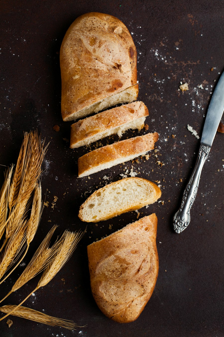 A sliced sourdough loaf beside a bread knife