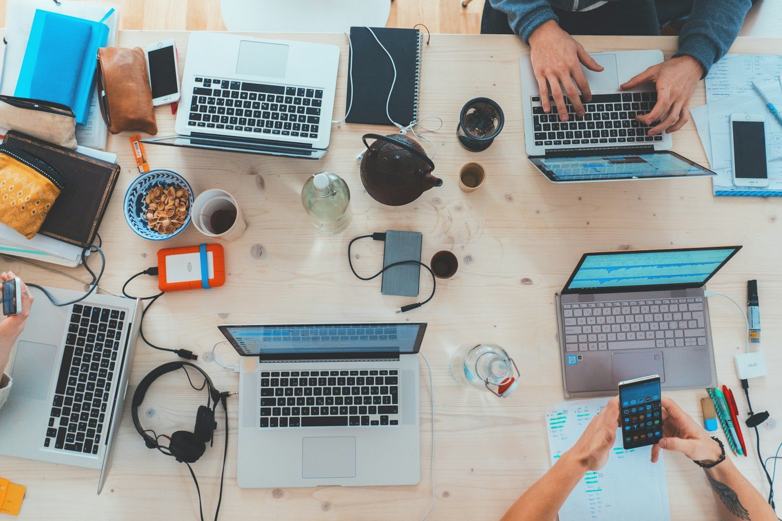 Two people at a table with laptops during a client meeting.